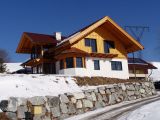 Haus mit Holzfassade im Obergeschoss